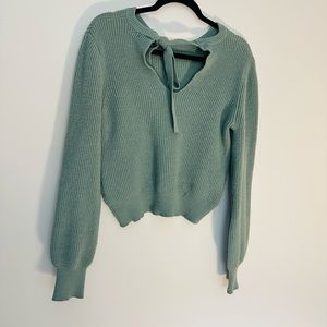 Women’s greenish sweater with cute tie back